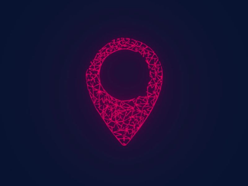 znak lokacije roze boje na teget pozadini