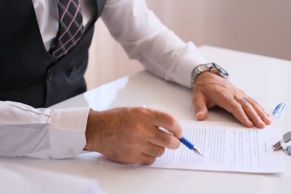 osoba potpisuje dokumente